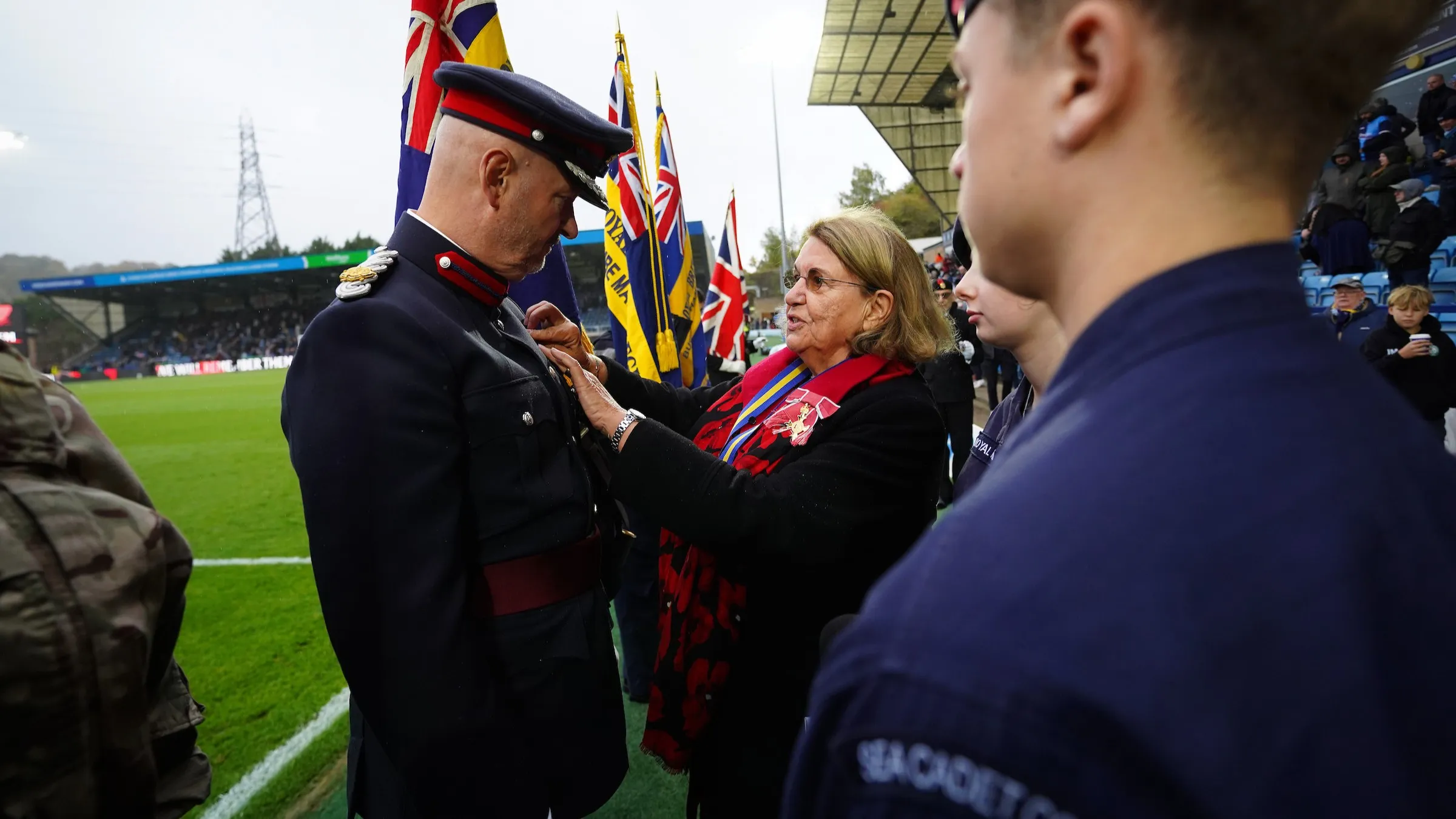 First poppy sold at Adams Park in half-time ceremony